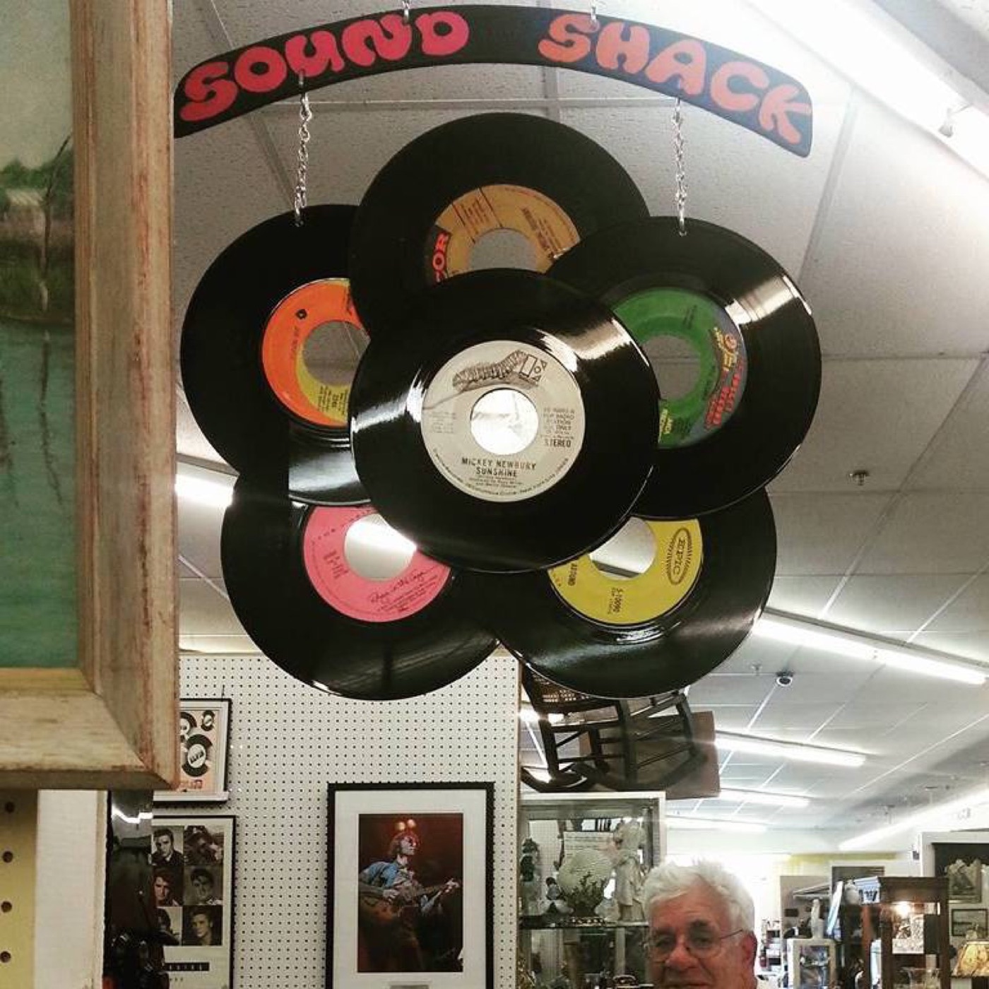 Sound Shack wall display: vinyl sleeves mounted above crates of records